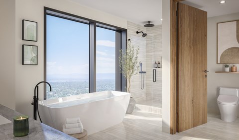 A modern bathroom with a large window overlooking the city.
