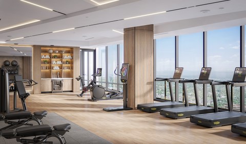 A gym with treadmills, exercise balls, and weights.