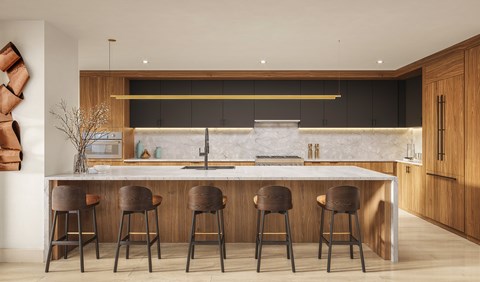 A modern kitchen with a bar area and four stools.