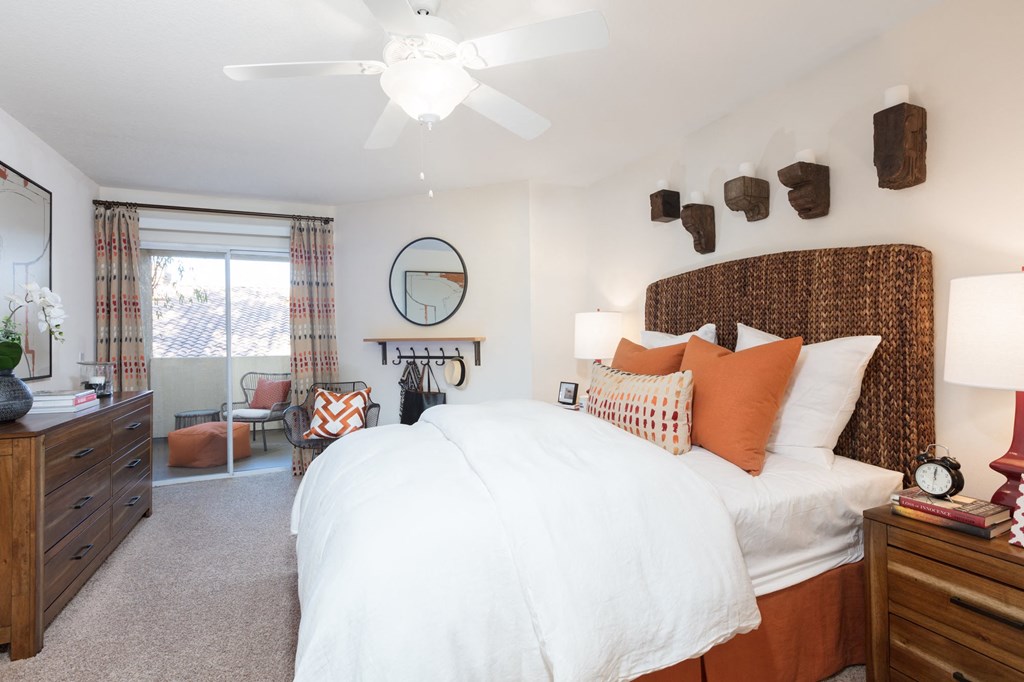 a bedroom with a bed and a ceiling fan