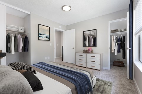 a bedroom with a bed and a closet with a dresser