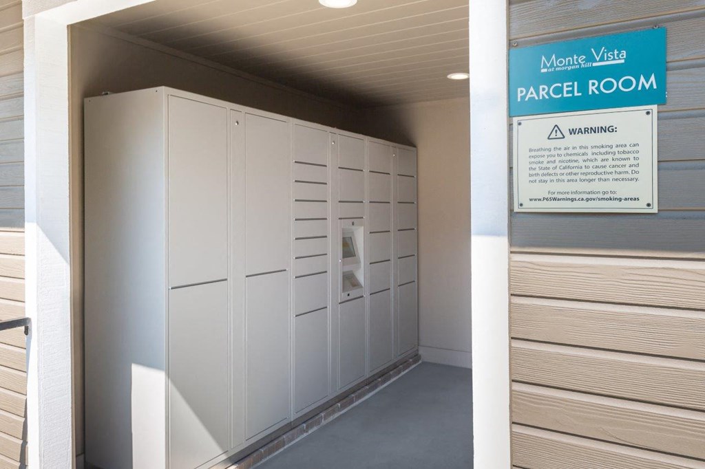 a passage room in a building with white lockers and a paper room sign