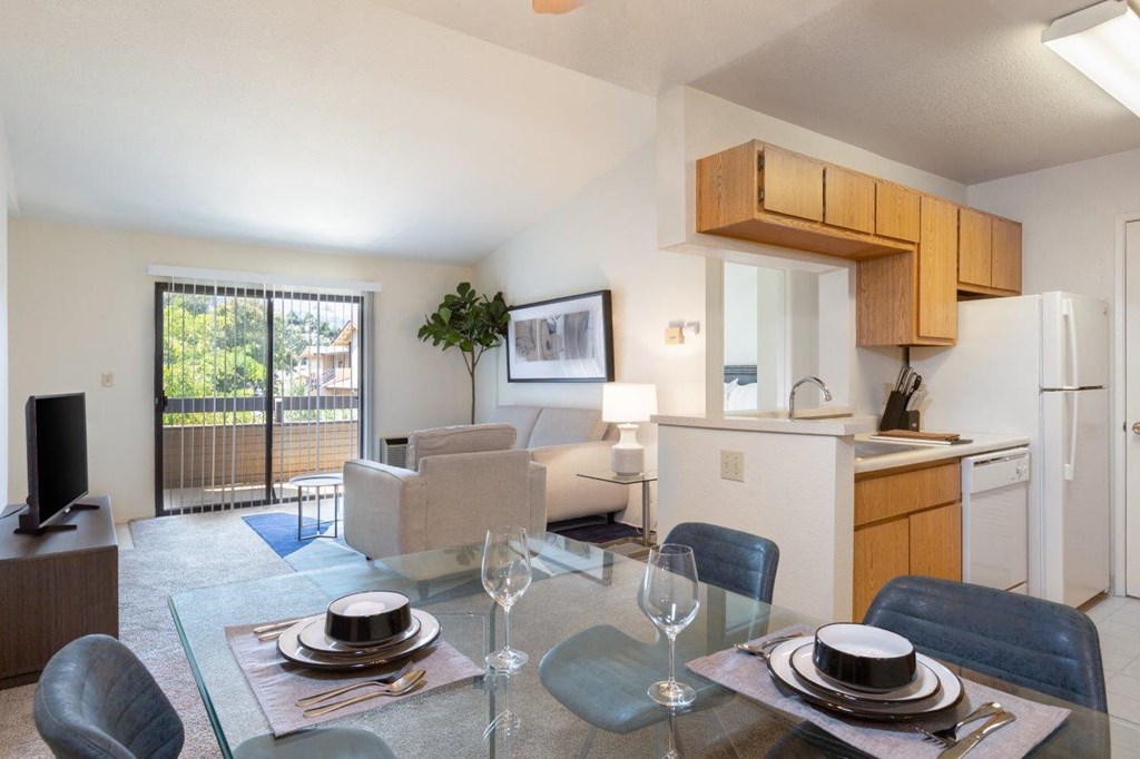 a kitchen and living room with a table and chairs
