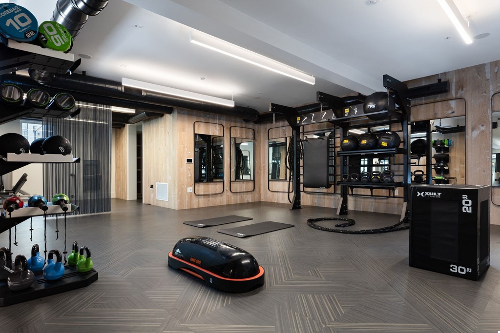 a home gym with a mouse and weights on the floor