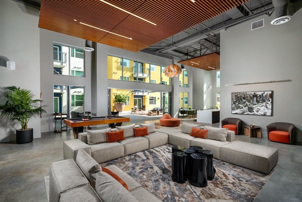 resident lounge with couches and TV inside of Aston at Gateway apartments in El Monte, California