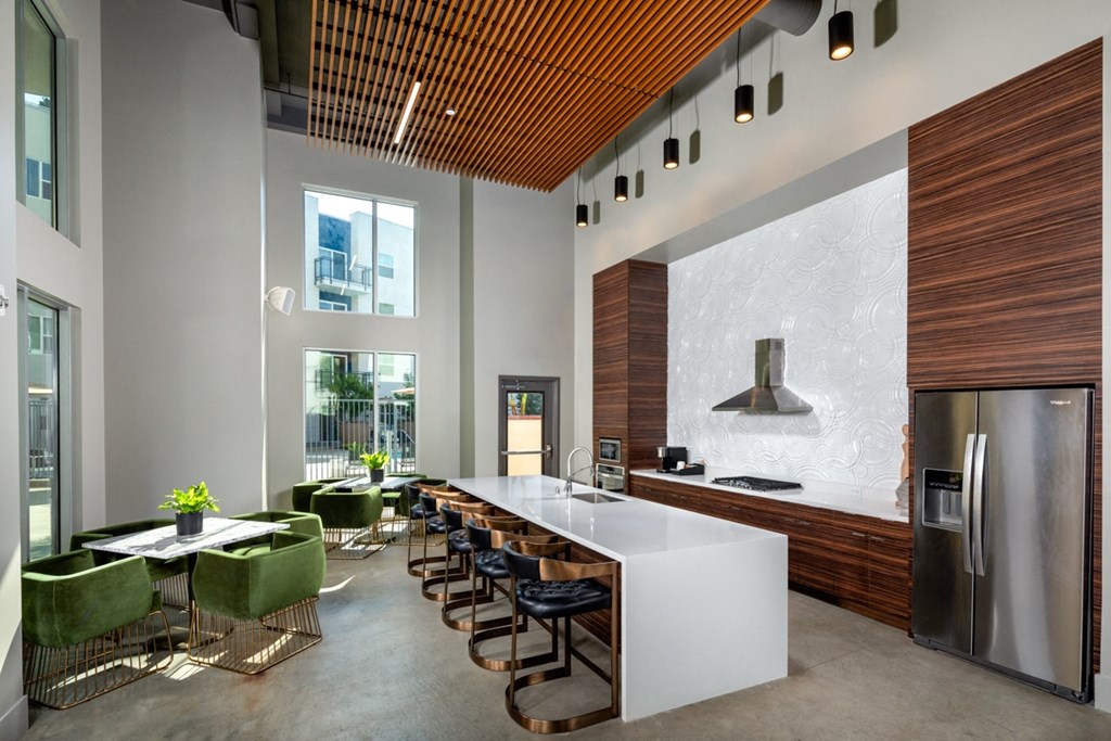 bar seating and range over at The Club Clubhouse Kitchen and Lounge inside Aston at Gateway apartments in El Monte