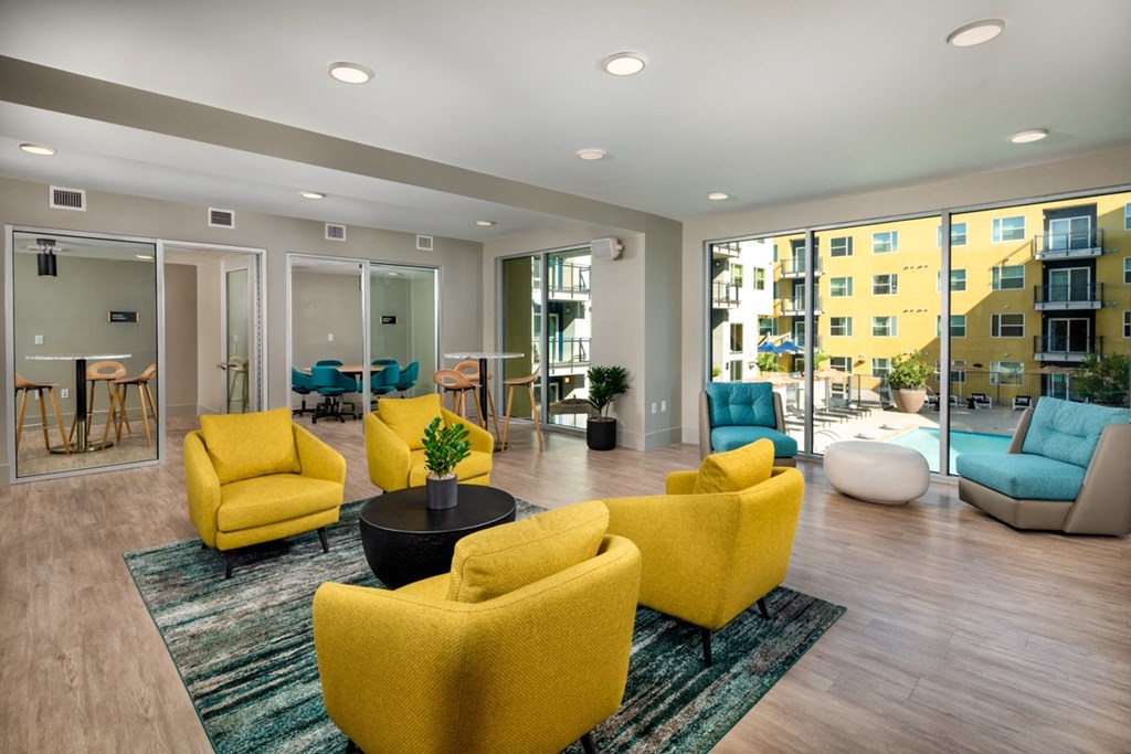 large coworking space with yellow chairs and private offices in Aston at Gateway apartments in El Monte, California
