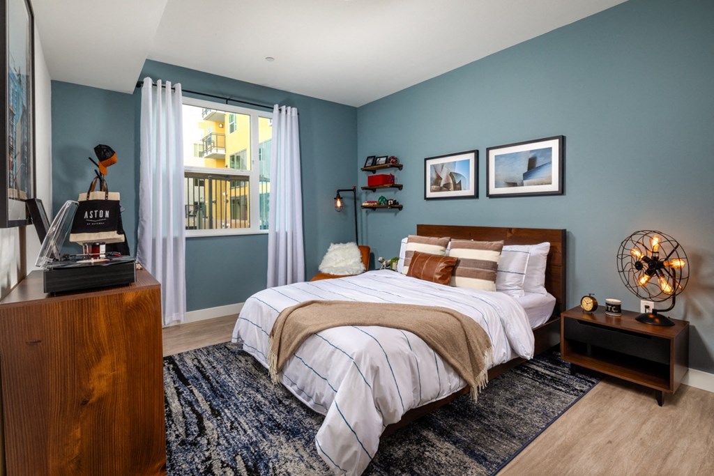 one-bedroom apartment in El Monte with bed and large window at Aston at Gateway apartments