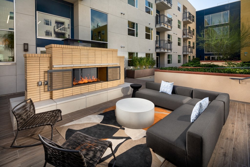 apartment with outdoor deck and fire lounge at Aston at Gateway apartments in El Monte, California