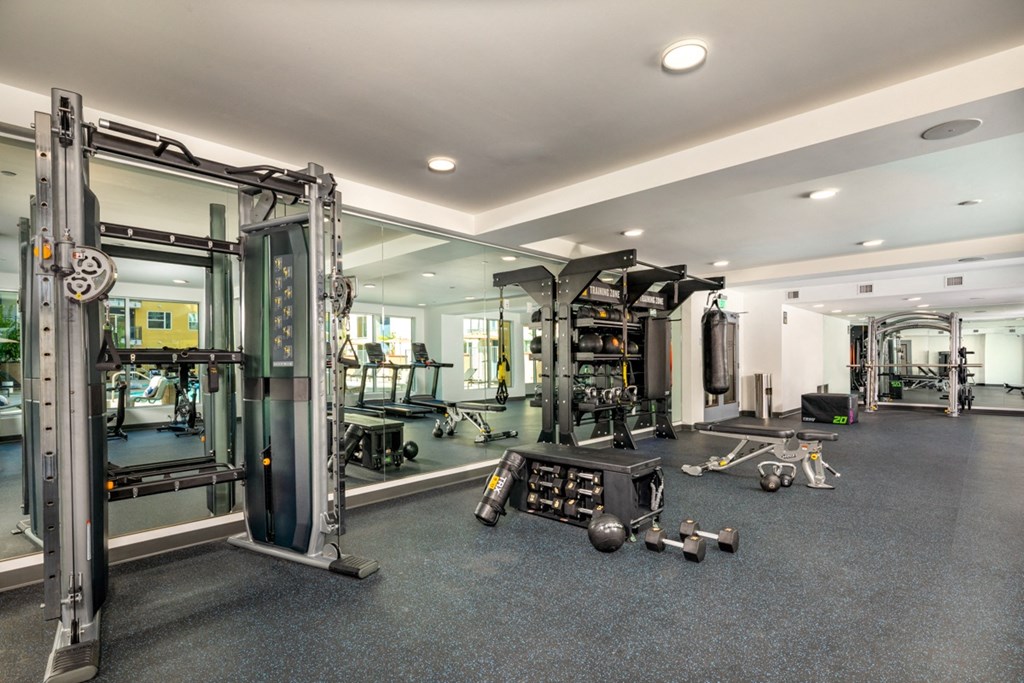 fully stocked fitness center with weight rack in apartment in El Monte at Aston at Gateway apartments