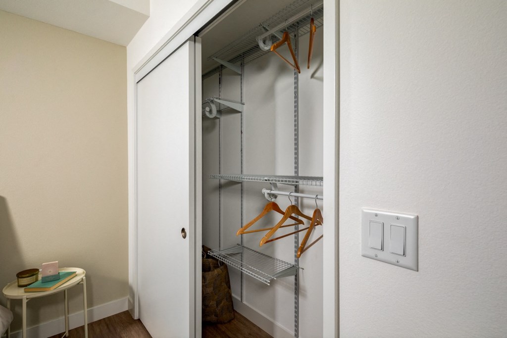 large closet with custom shelving at Aston at Gateway apartments in El Monte, California