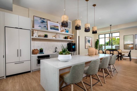 A modern kitchen with a dining table and chairs.