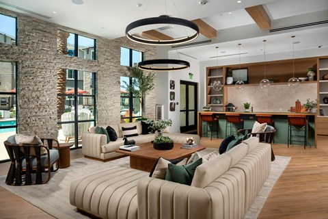 A modern living room with a large sectional sofa and a coffee table.