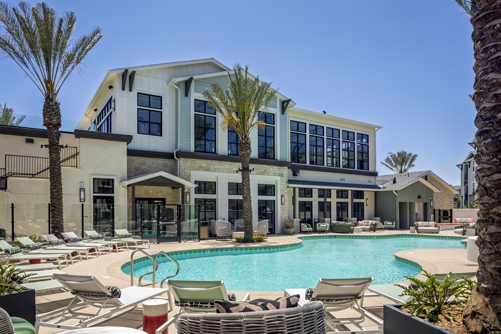 A large building with a pool in front of it.