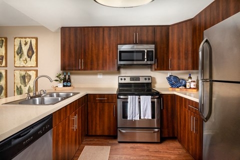 a kitchen with stainless steel appliances and wooden cabinets