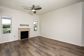 A room with a fireplace and a ceiling fan.
