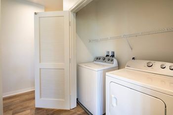A white washing machine and dryer in a laundry room.