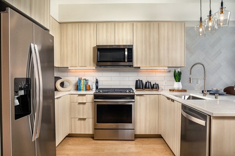 a kitchen with stainless steel appliances and wooden cabinets