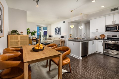 A modern kitchen with a dining table and chairs.