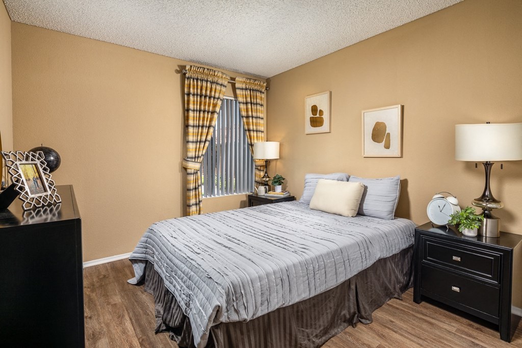 a bedroom with a bed and a dresser and a window