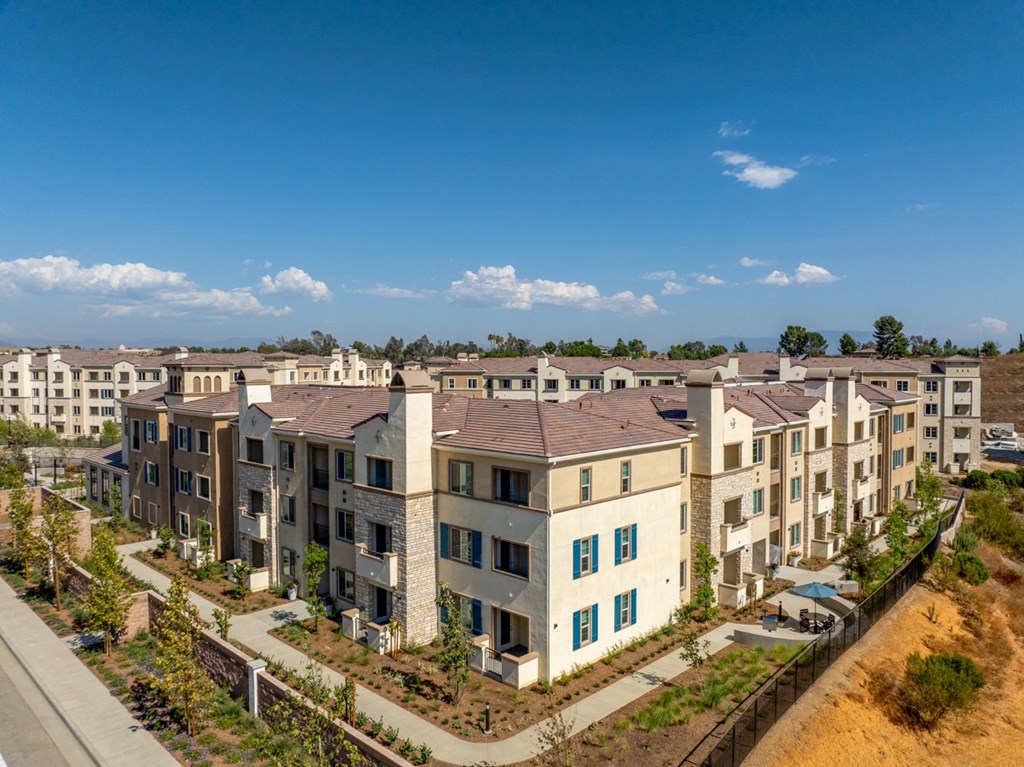 an aerial view of an apartment complex with a blue sky