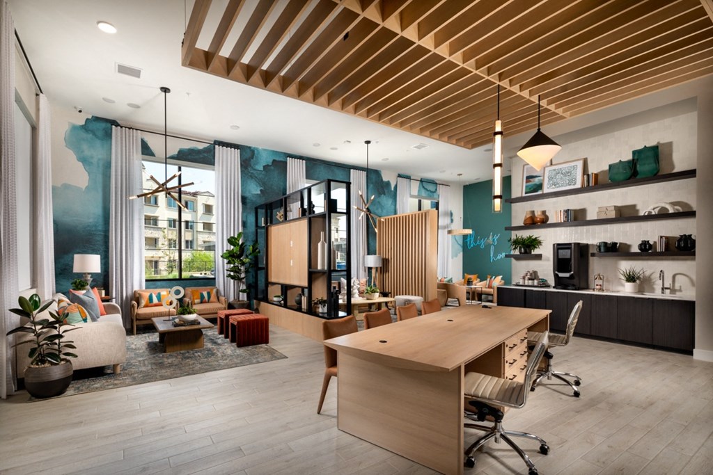 a leasing office with a desk and lounge areas