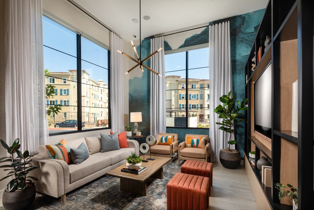 a clubhouse with large windows and a couch and a table