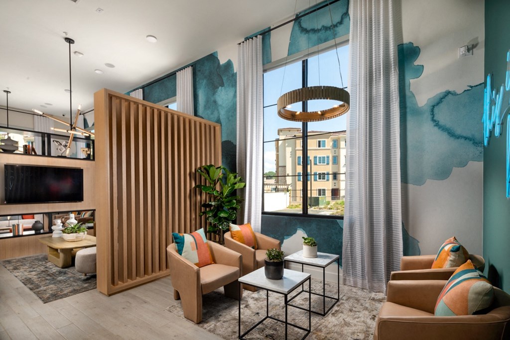 a clubhouse with couches and tables and a large window