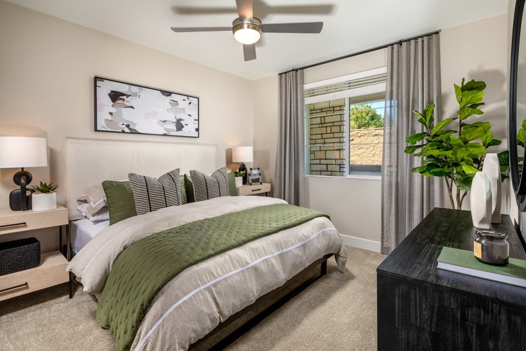 a 1-bedroom primary room with a bed and a ceiling fan