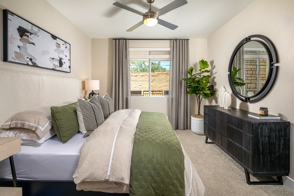 a 1-bedroom primary room with a bed and a ceiling fan