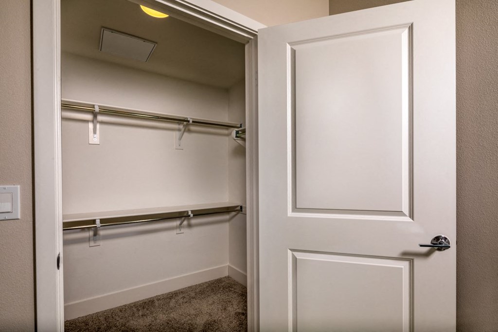 a 2-bedroom guest closet with a white door