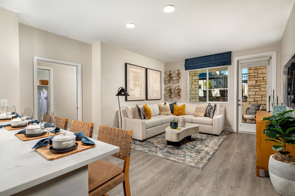 a living room and dining room with couches and a table