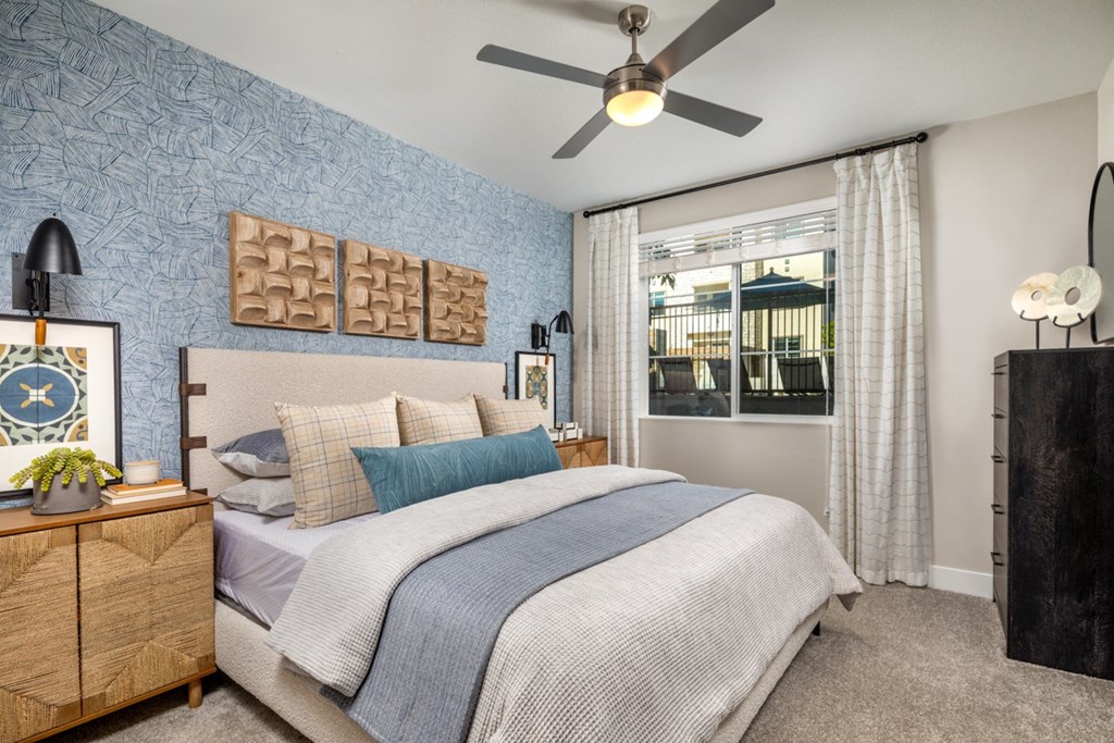 a bedroom with a bed and a ceiling fan