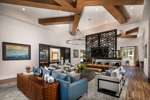 A modern living room with a large sofa set and a fireplace.