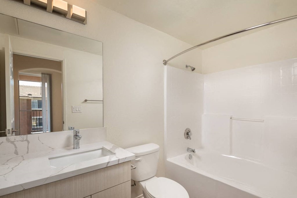 Bathroom with a sink and a toilet and a tub at Casoleil,  92154