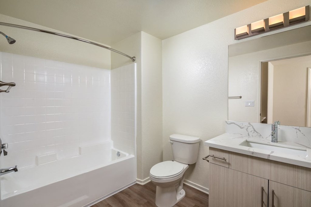 Bathroom with a toilet and a tub and a sink at Casoleil, 92154