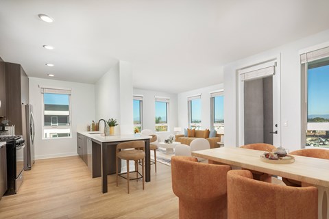 A modern kitchen with a dining table and chairs.