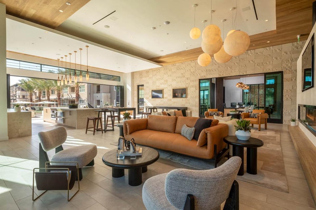 A modern living room with a stone wall and a large window.