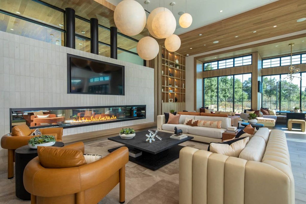 Clubhouse lounge with fireplace and seating at The Croft Wildomar apartments.