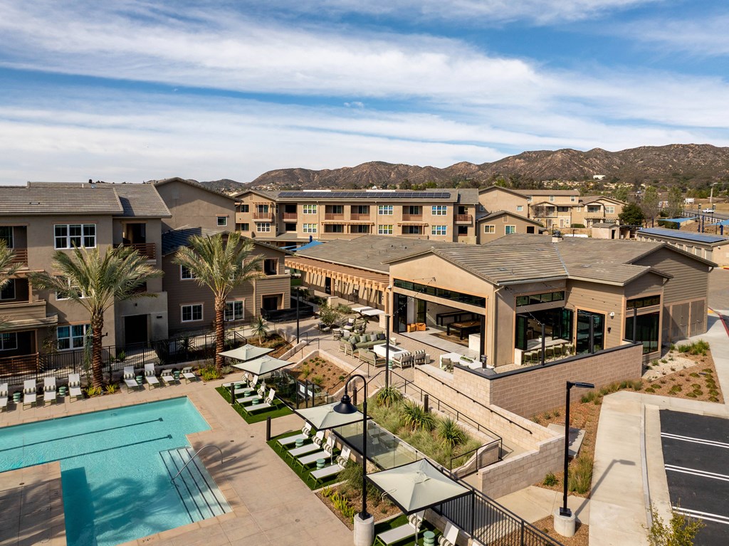 A large building complex with a pool in the foreground.