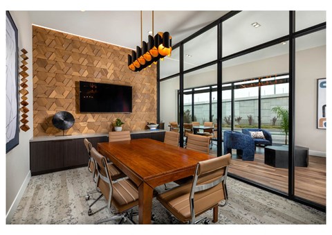 A modern dining room with a wooden table and chairs.
