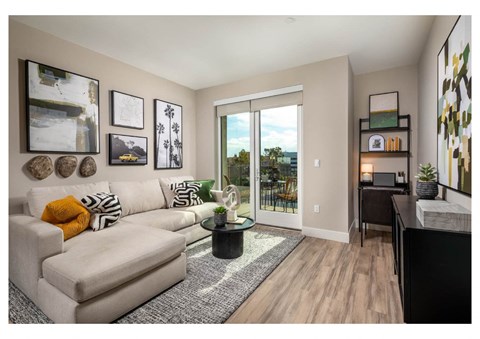 A living room with a white couch and a coffee table.
