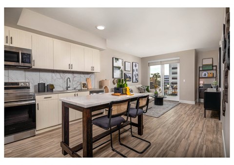 A kitchen with a table and chairs in the middle of the room.