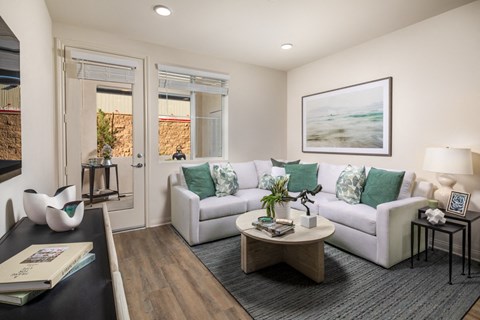 A living room with a white couch and a coffee table.