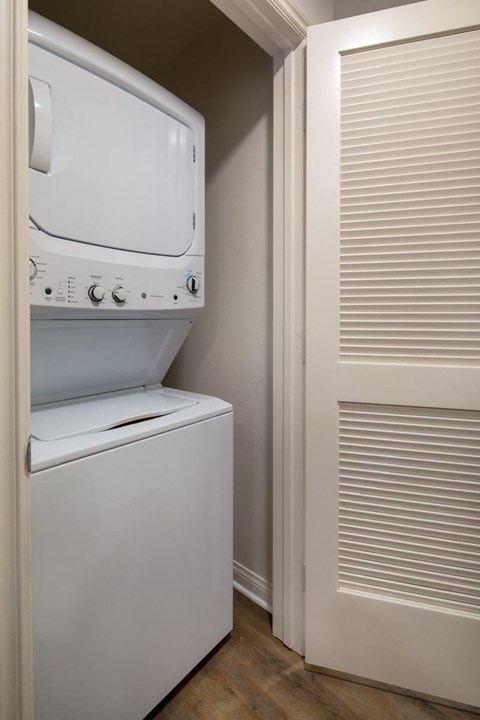 A white dryer and washer in a small laundry room.