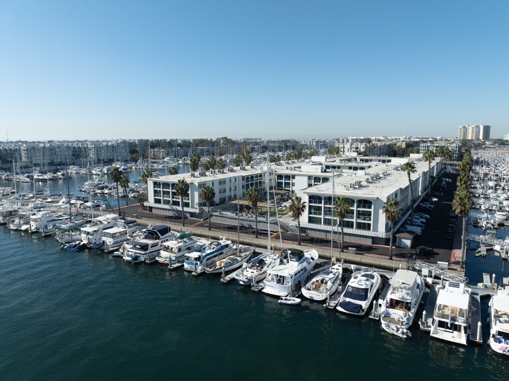 A marina with boats docked and a building in the background.