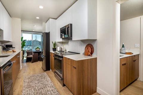 A modern kitchen with wooden cabinets and a large island.
