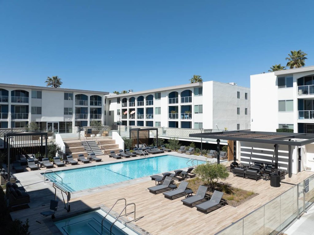 A large white building with a pool in front.
