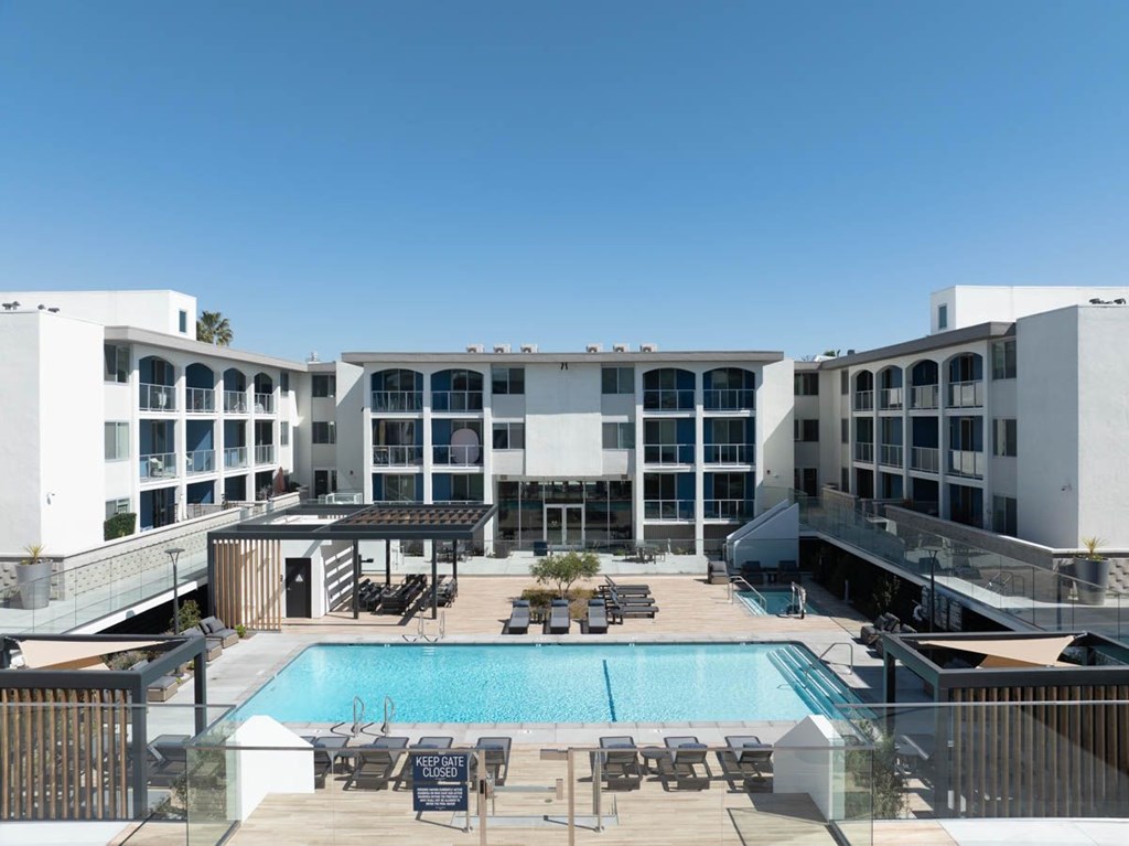 A large white building with a pool in the middle of it.