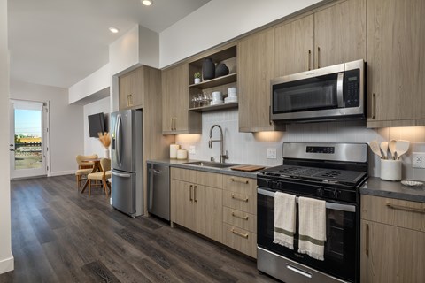 A modern kitchen with a stainless steel oven and wooden cabinets.